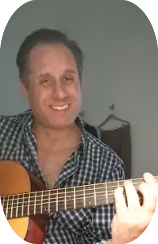Bryan Sean Byrne performing with his guitar